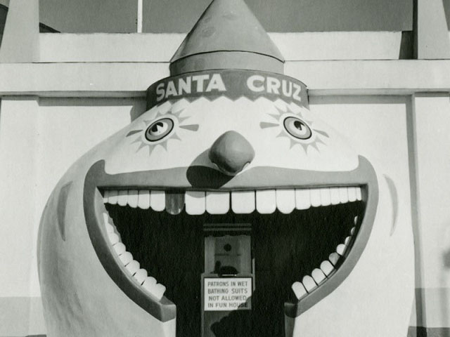 SC Boardwalk black and white image of fun house entrance, clown with mouth open