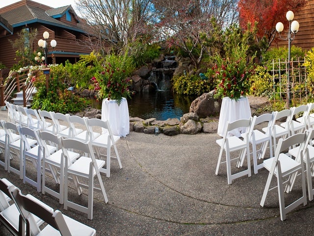 Outdoor wedding ceremony set up at Seacliff Inn in their outdoor garden. 