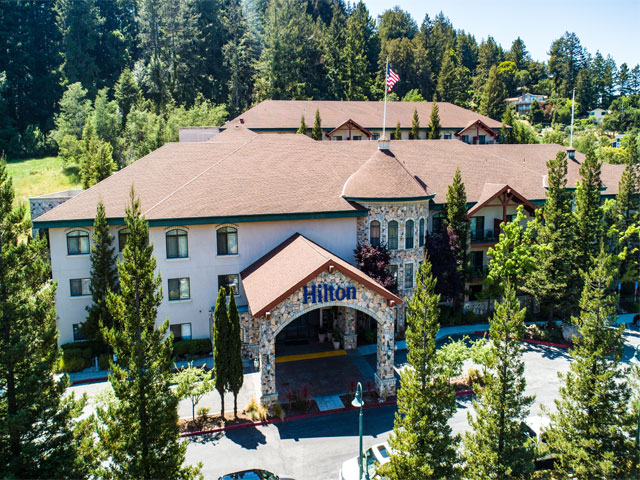 Exterior image of Hilton Santa Cruz /Scotts Valley. The property is surrounded by redwoods.
