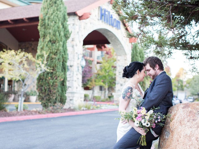 Couple taking photos in front of Hilton Santa Cruz/ Scotts Valley