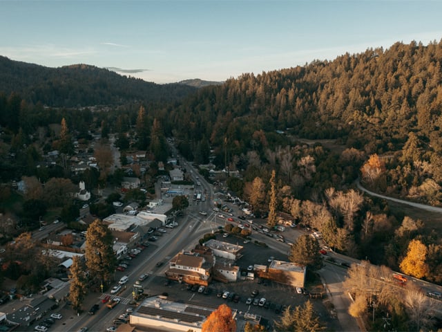 Aerial shot over Felton. Shows mountains and redwoods with roads running through the santa cruz mountains. By Ben Ingram