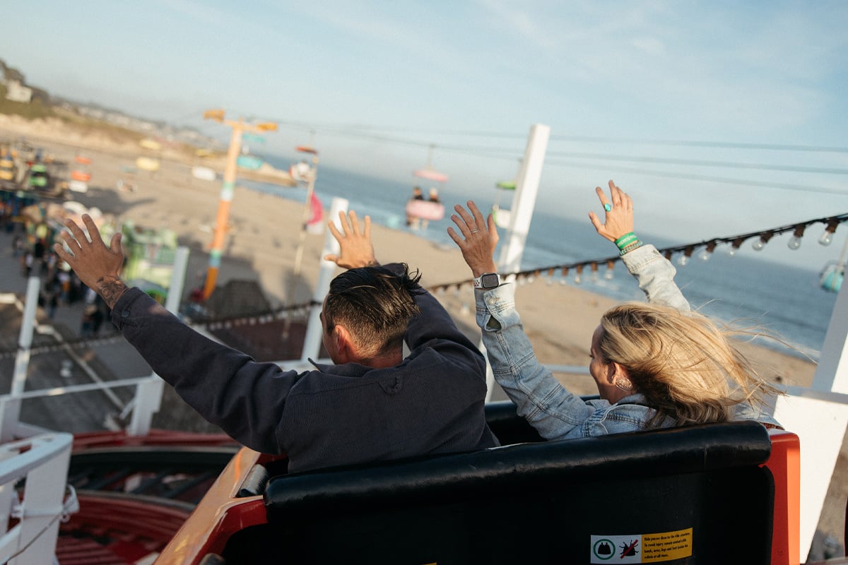 Two individuals riding the Giant Dipper at the Santa Cruz Boardwalk. Photographed by Ben Ingram
