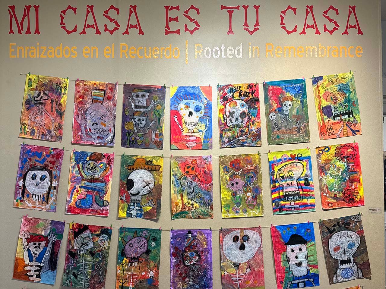 Student Dia de los Muertos Art collection on a wall
