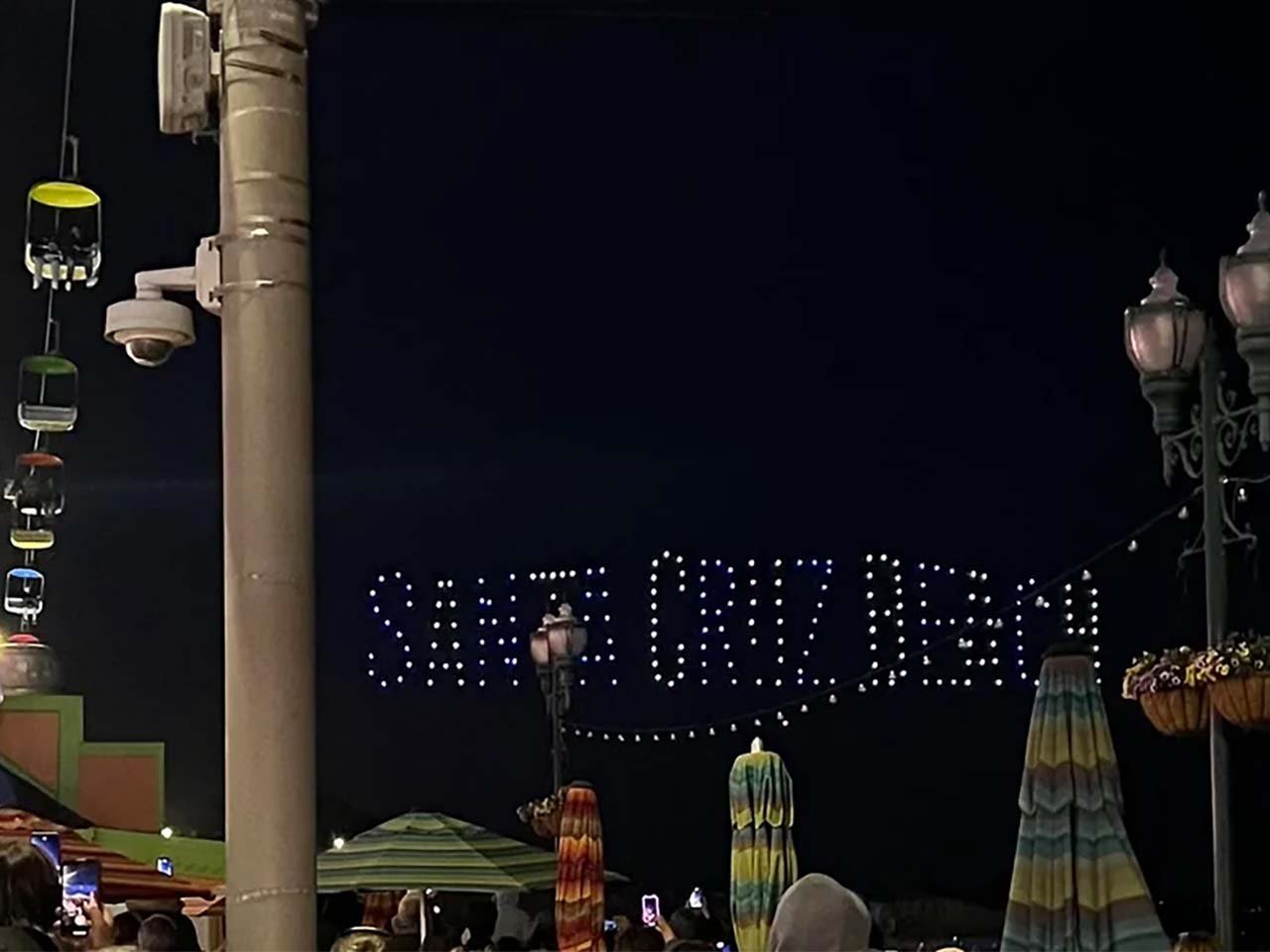 Drones spelling out Santa Cruz Beach over amusement park rides