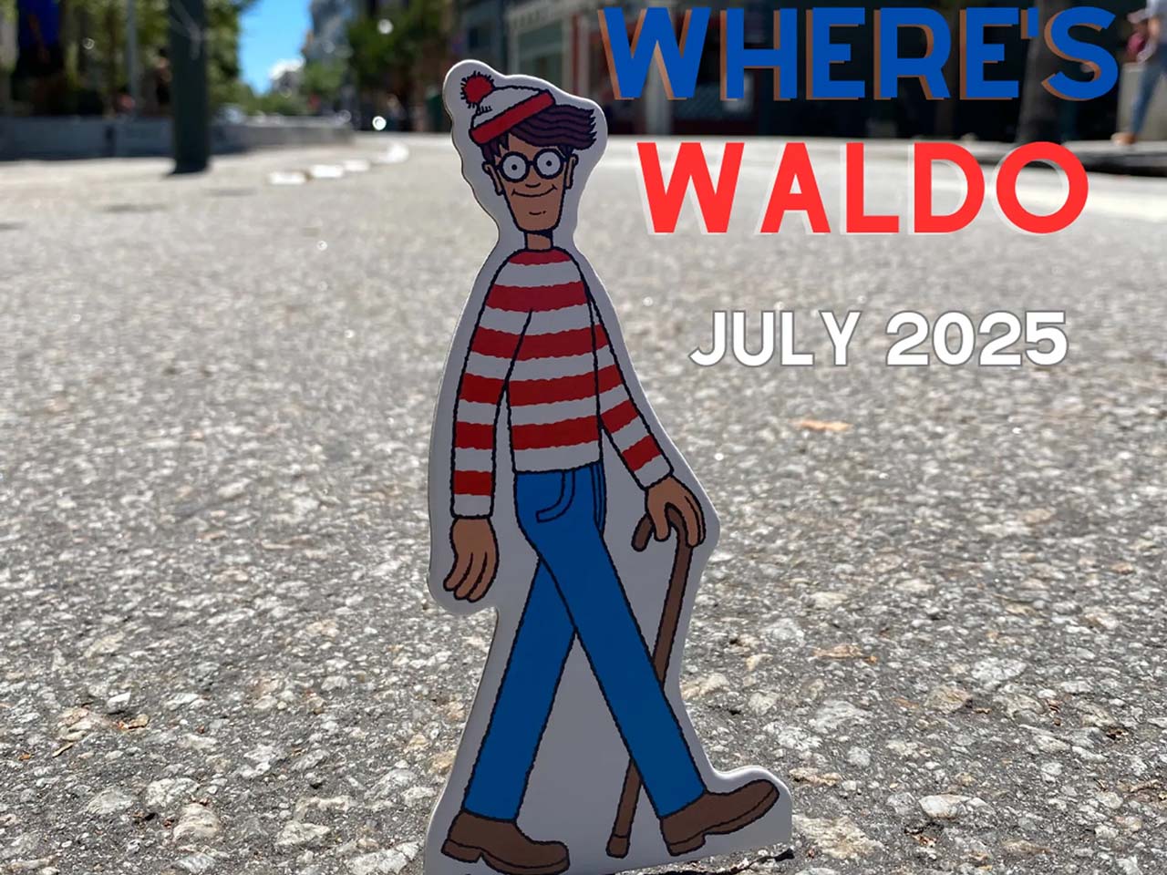 A small cutout image of Waldo walking in a human sized street in Downtown Santa Cruz.