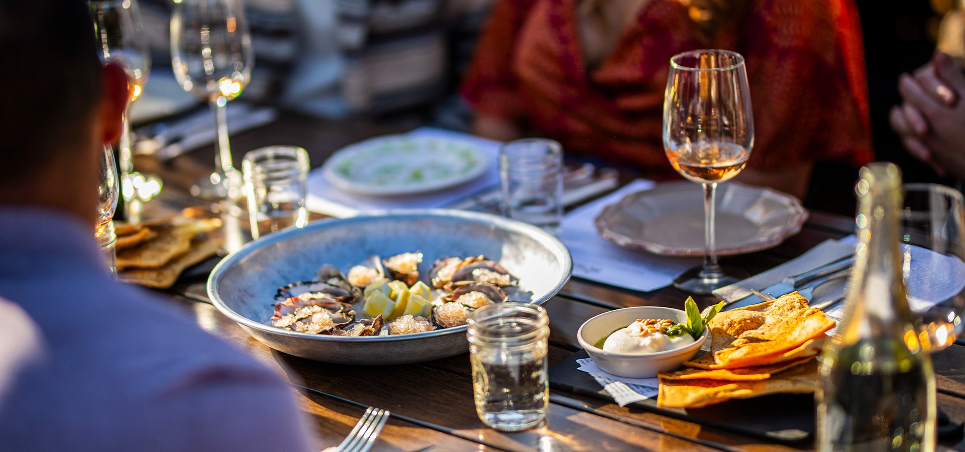 Patrons enjoying oysters at Home Soquel. Photographed by Impact Creative