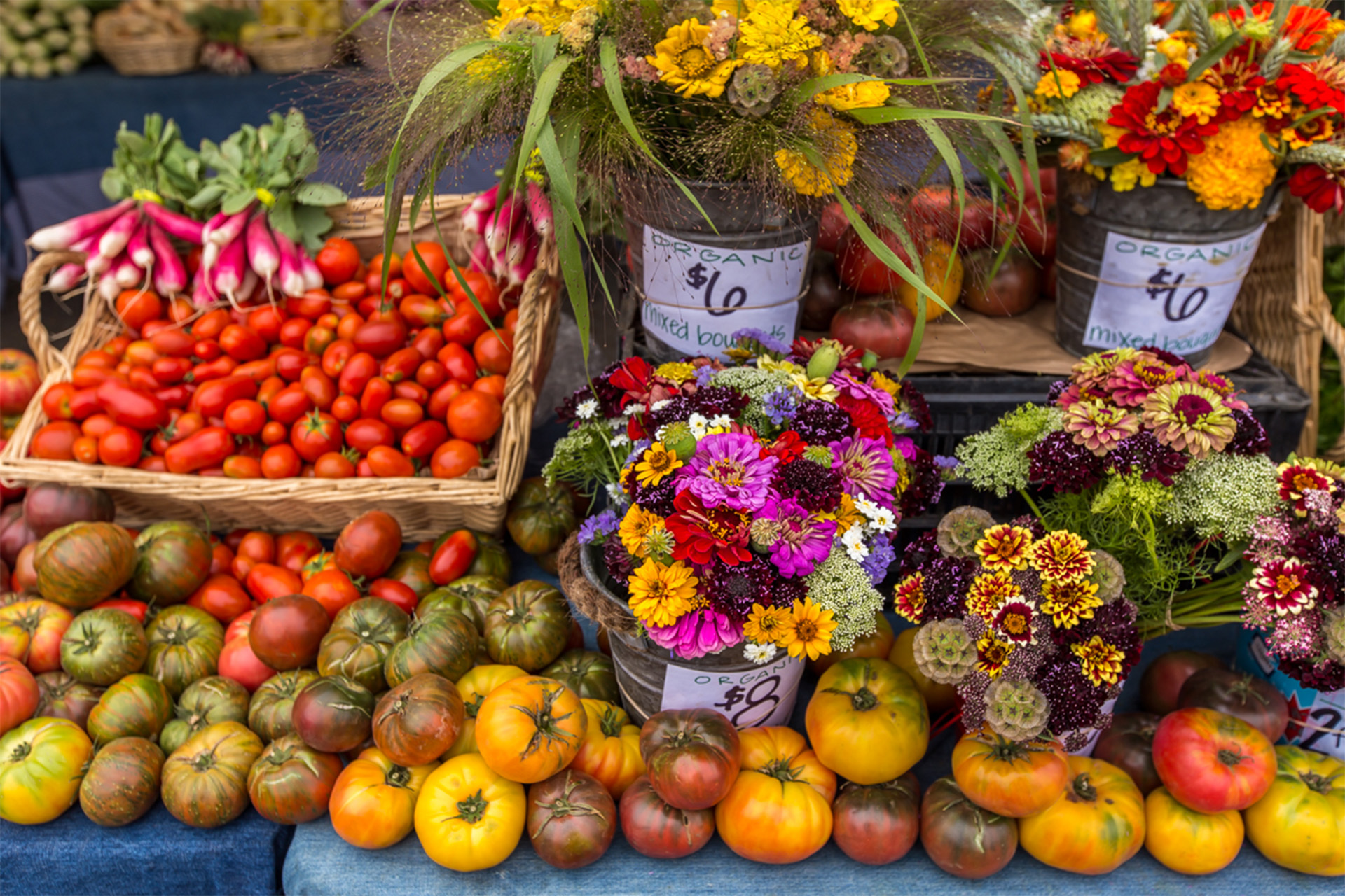 Tomatoes and freshly picked flowers at the farmers' market. Photographed by Garrick Ramirez