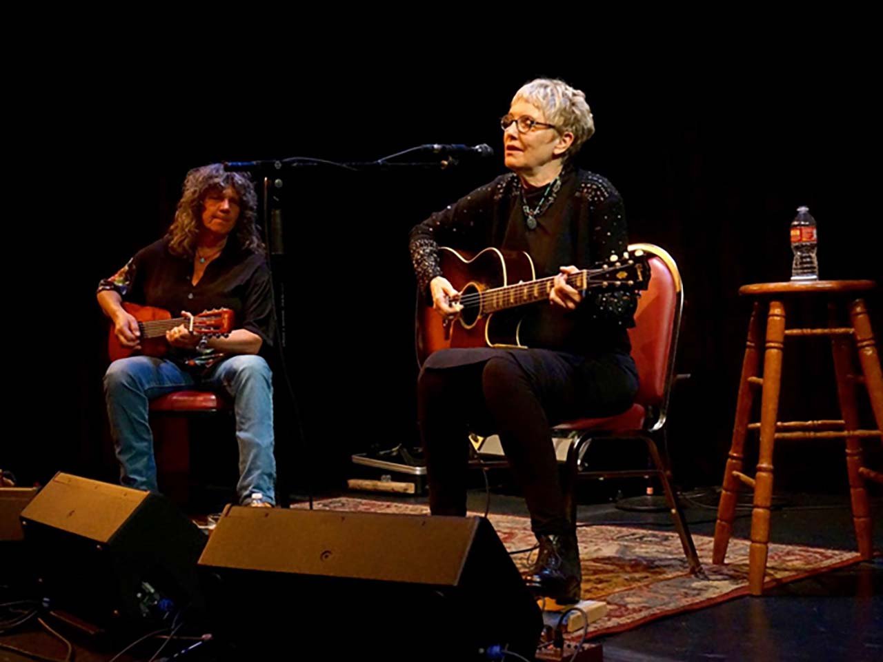 Eliza and Nina playing guitars and singing.