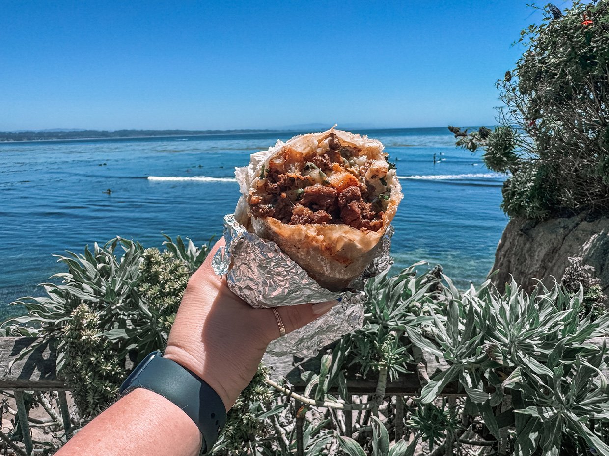 Burrito from The Point Market with the ocean in the background. Photographed by Jenn Day