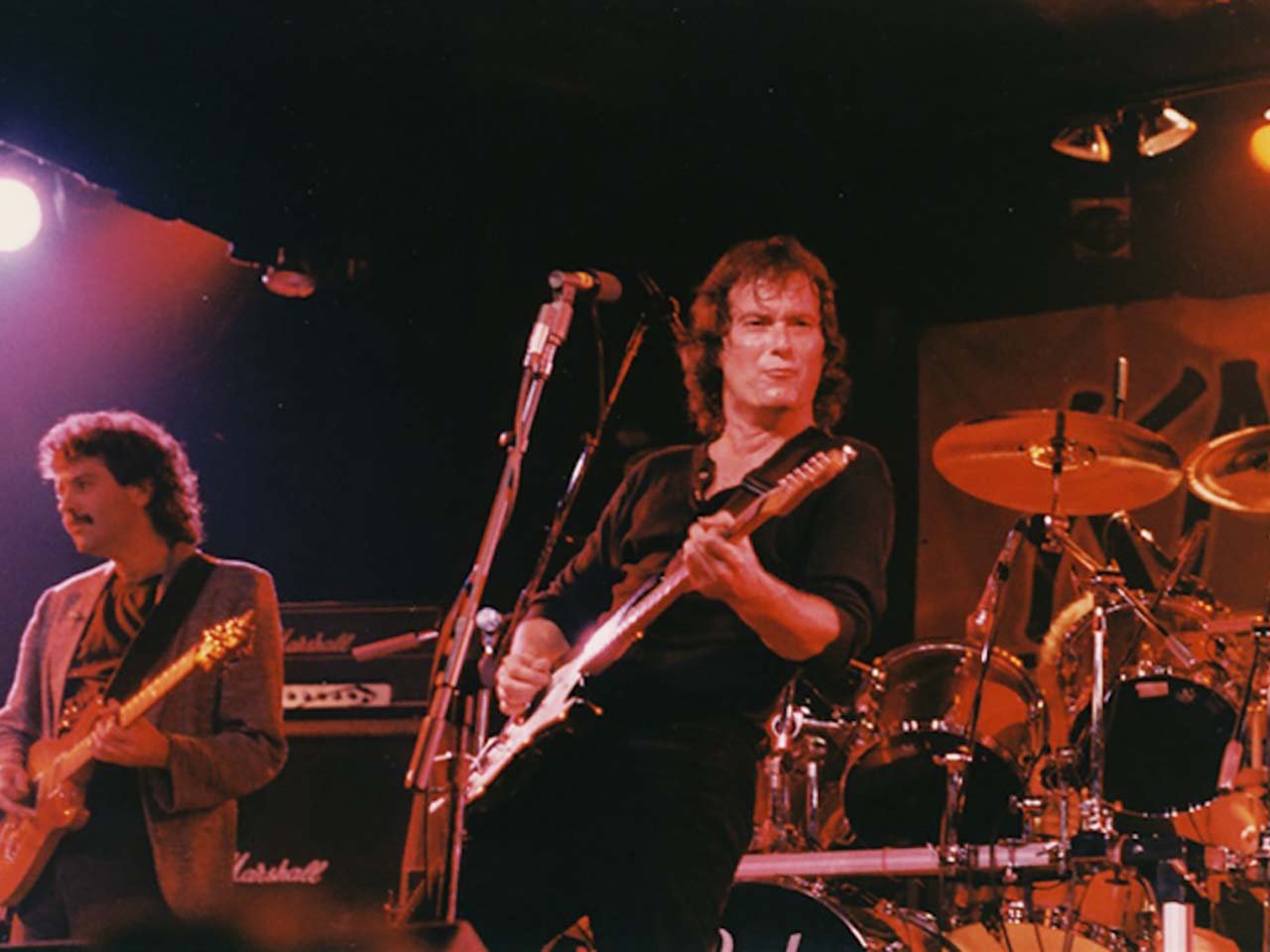 70's band rocking out on a stage