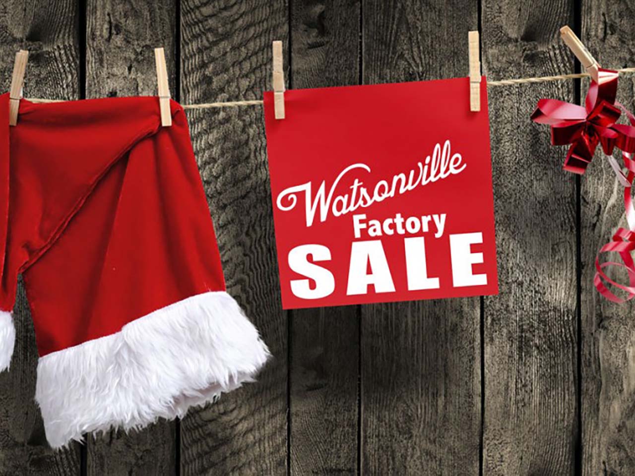 Holiday Hat and bow with a Watsonville Factories sign hanging from a clothesline.