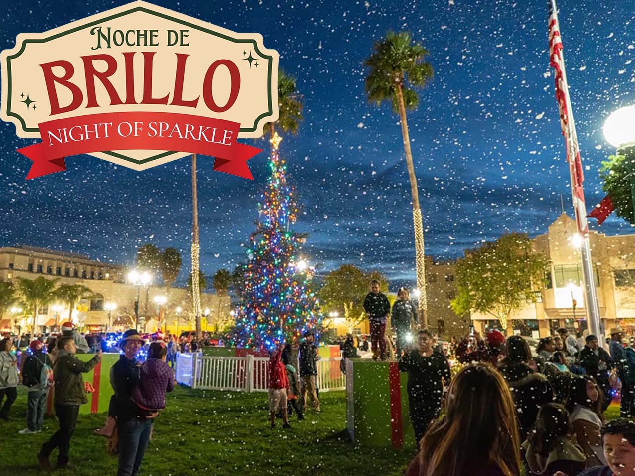 Families around lighted palm trees and a Christmas tree playing as fake snow is blown around