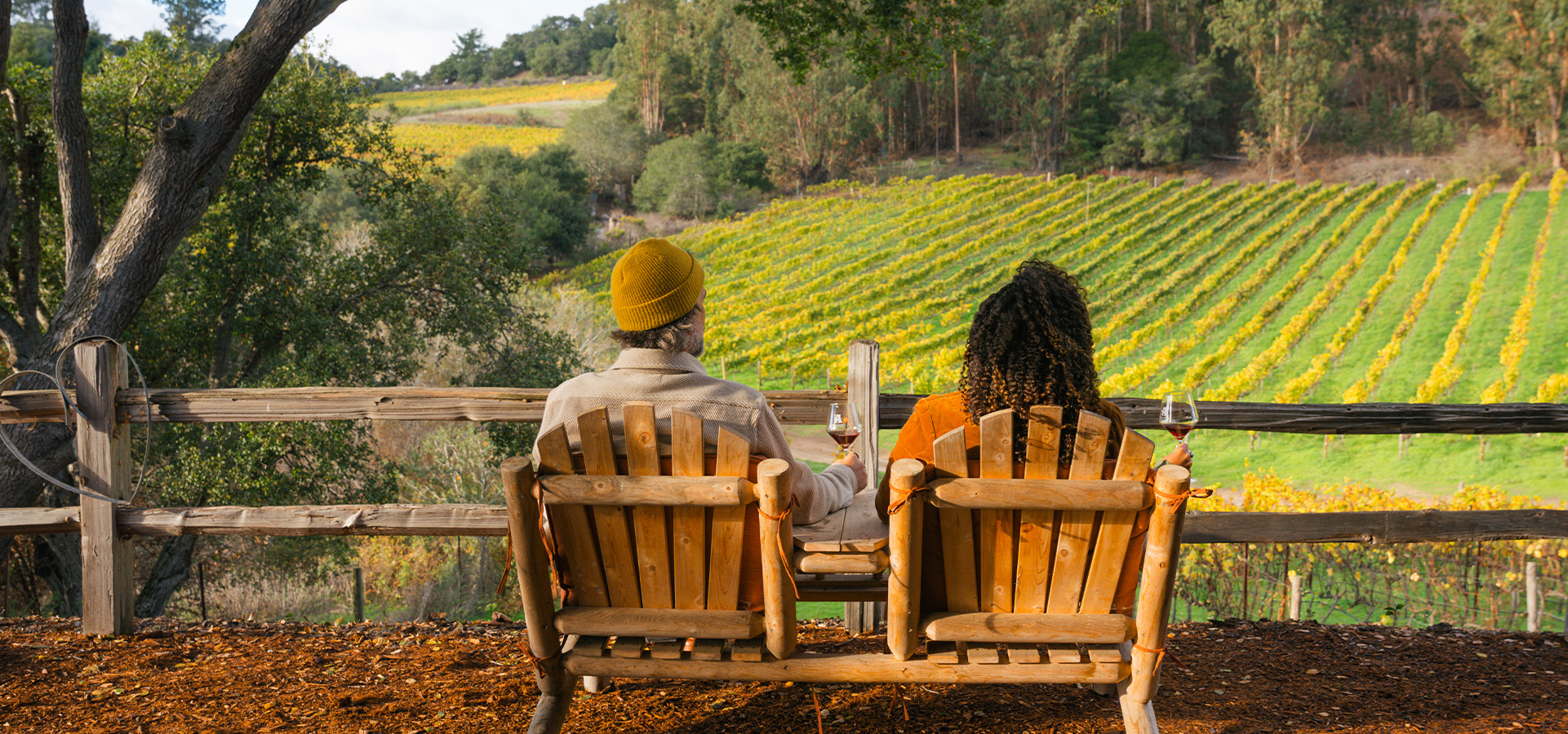 Two individuals enjoying a wine tasting while enjoying the vineyards at Alfaro Family Winery. Photographed by Liz Birnbaum, The Curated Feast