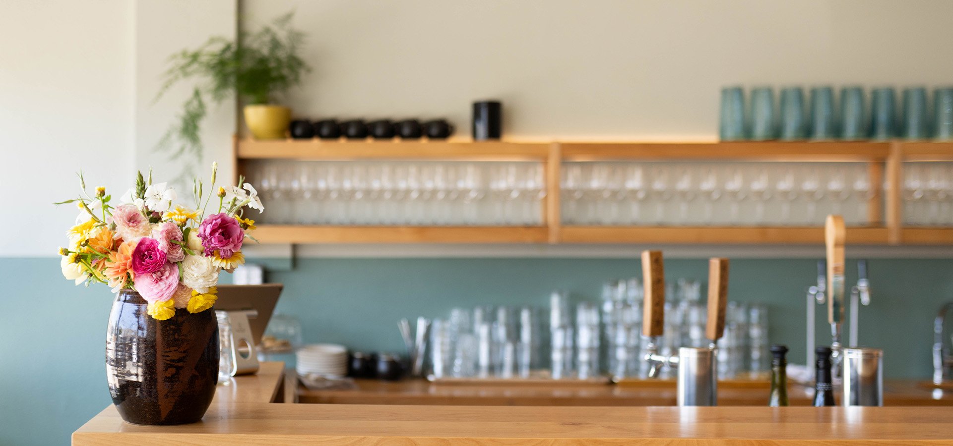Counter with bouquet of flowers at Midway Restaurant. Photographed by Liz Birnbaum, The Curated Feast