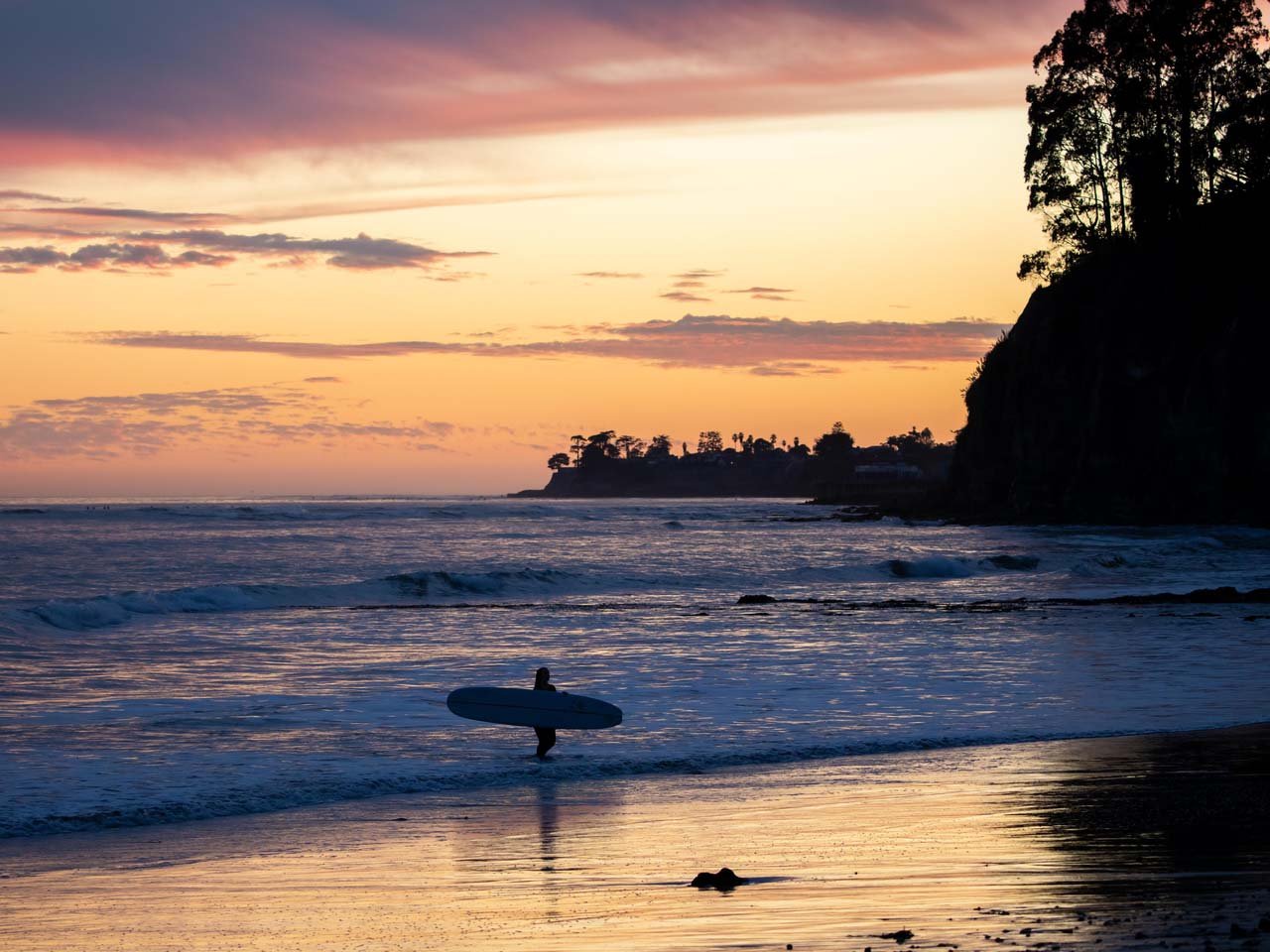 Image of surfer silhouette at sunset at New Brighton Beach