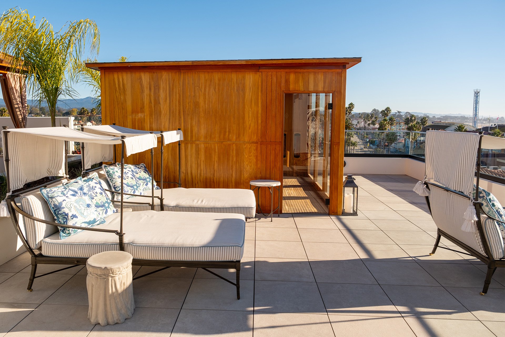 Rooftop sauna and lounge chairs with a view of the mountains and ocean at La Bahia Hotel & Spa