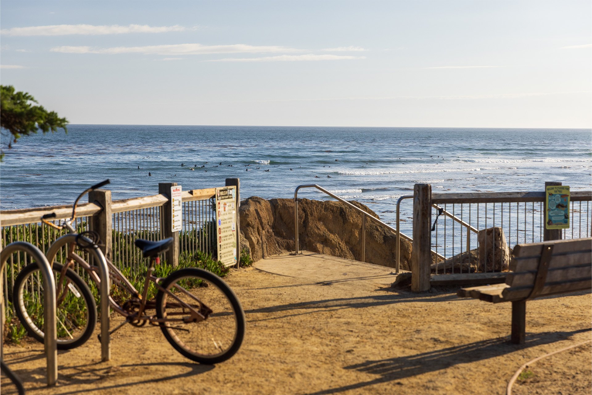 Bike parked at Pleasure Point with surfers in the background