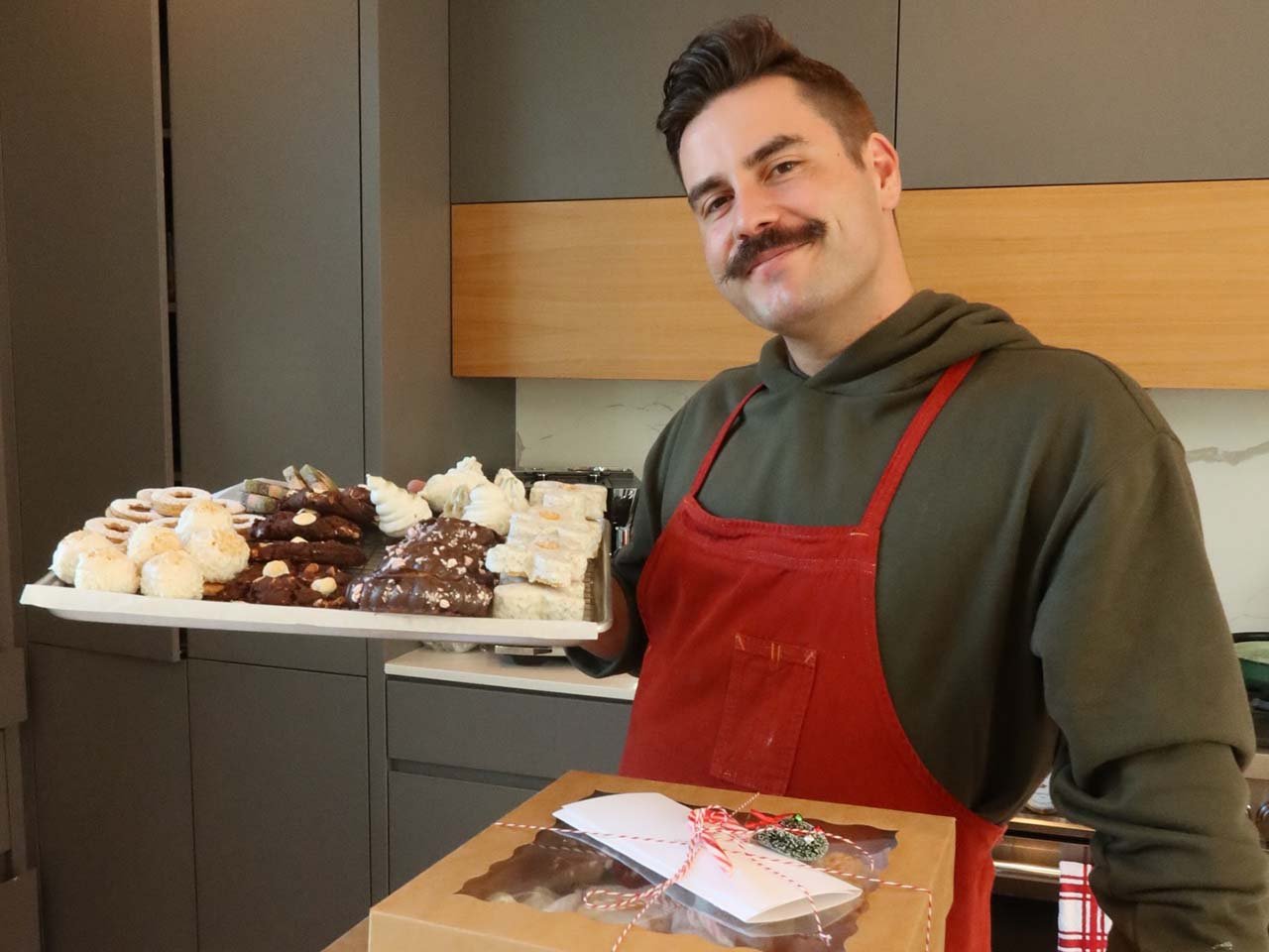 Chef showing off his specialties from a donut pop up business