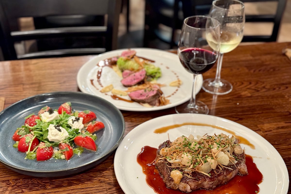 Dishes and glasses of wine from the Trestles menu. Photographed by Monica Multer