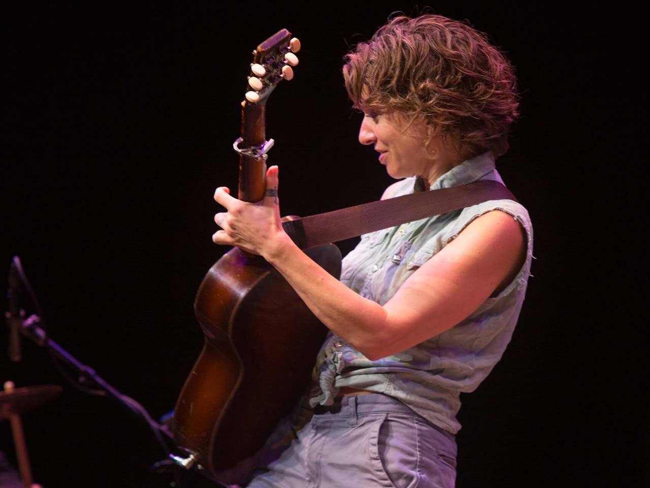 Ani playing an acoustic guitar.