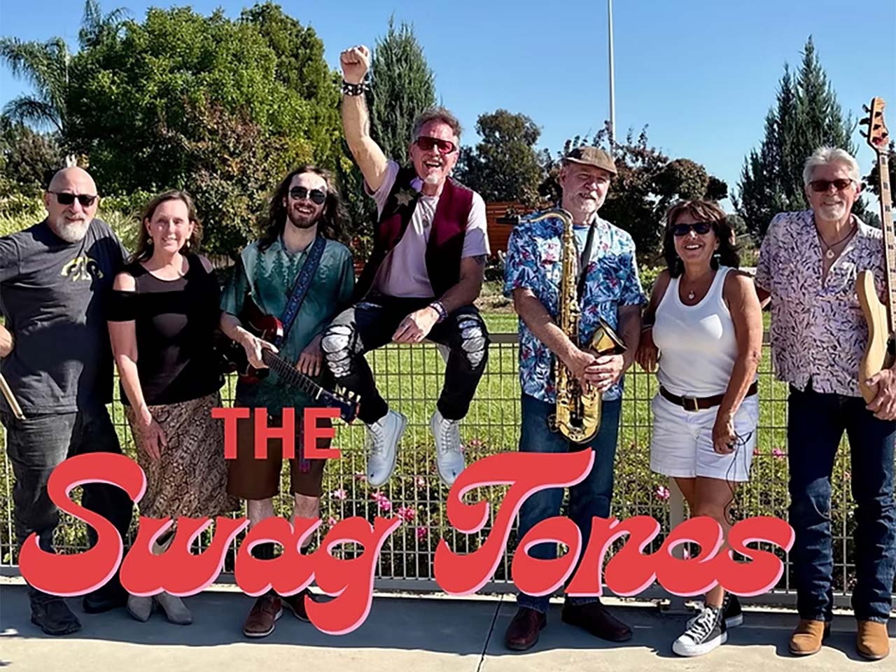 Band with logo in front of them