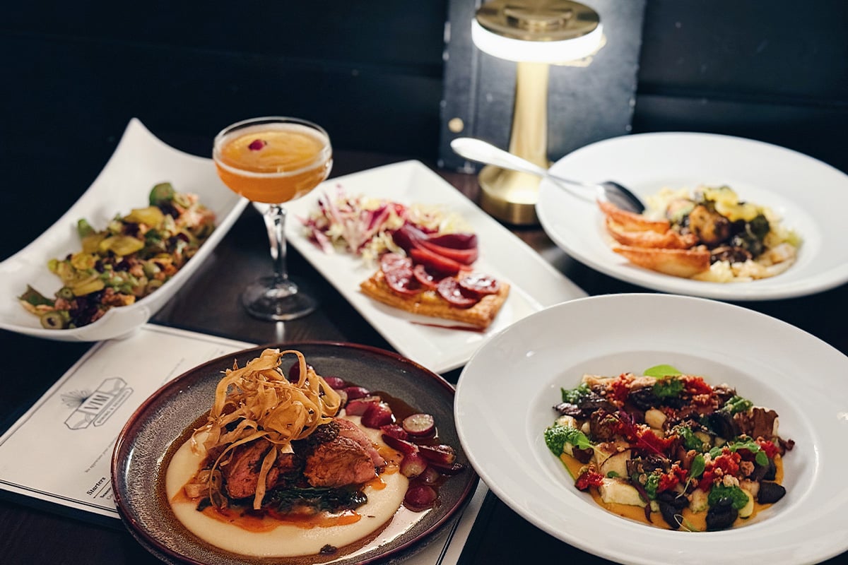 Plates of entrees and appetizers at VIM. Photographed by Monica Multer