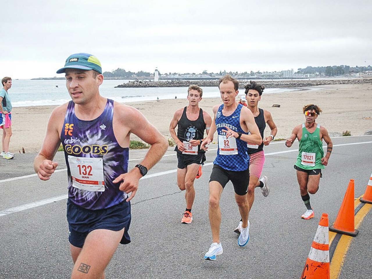 Runners on paved road by the beach