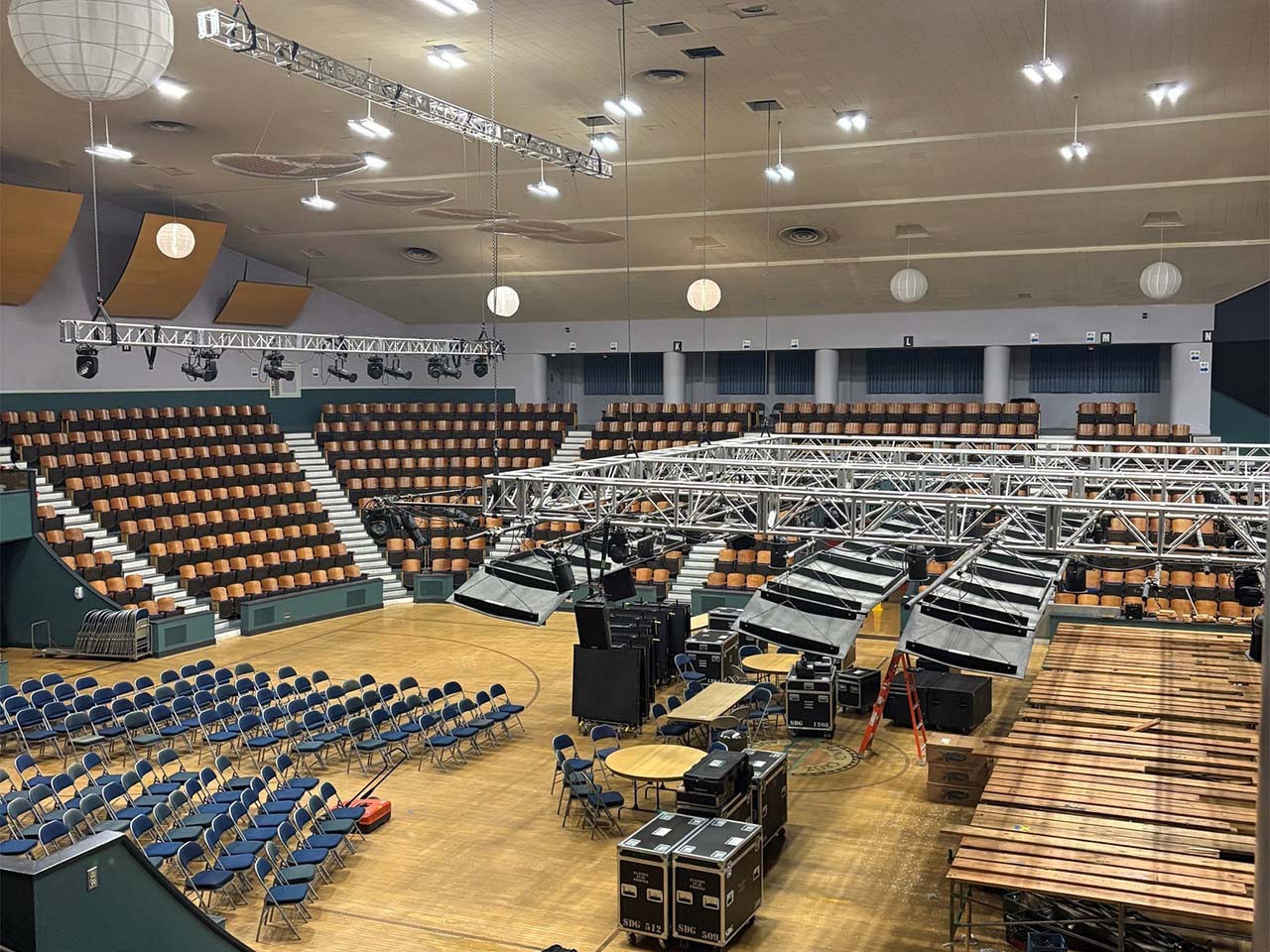A view from up high of a high tech modern concert set up. Art deco details in the building are visible