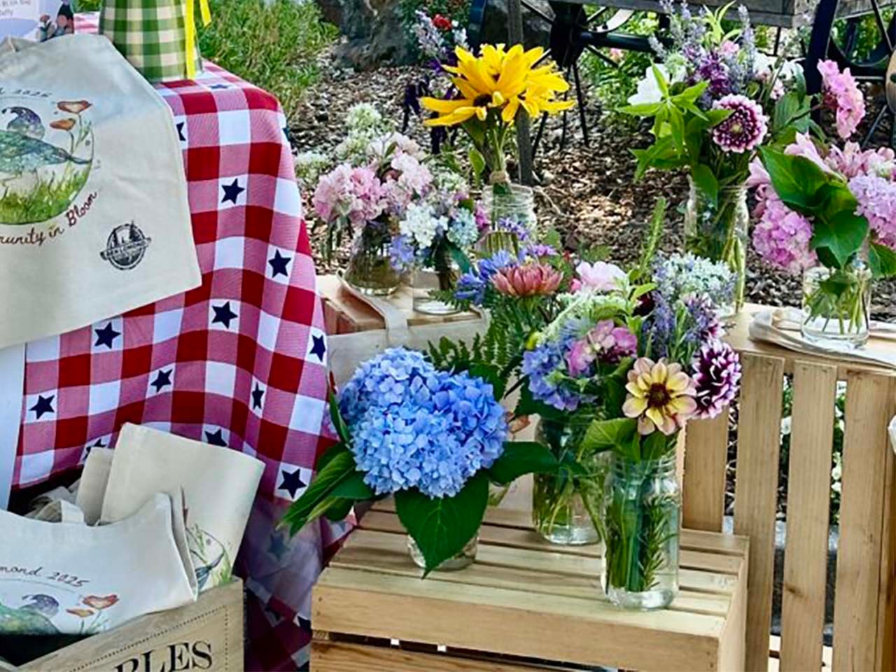 Arranged flowers in vases and local tote bags arranged beautifully