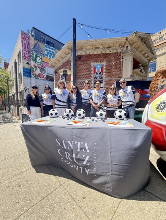 Visit Santa Cruz County staff in front of their FIFA themed soccer balls and painted MAH red ball as a soccer ball for FIFA World Cup 2026