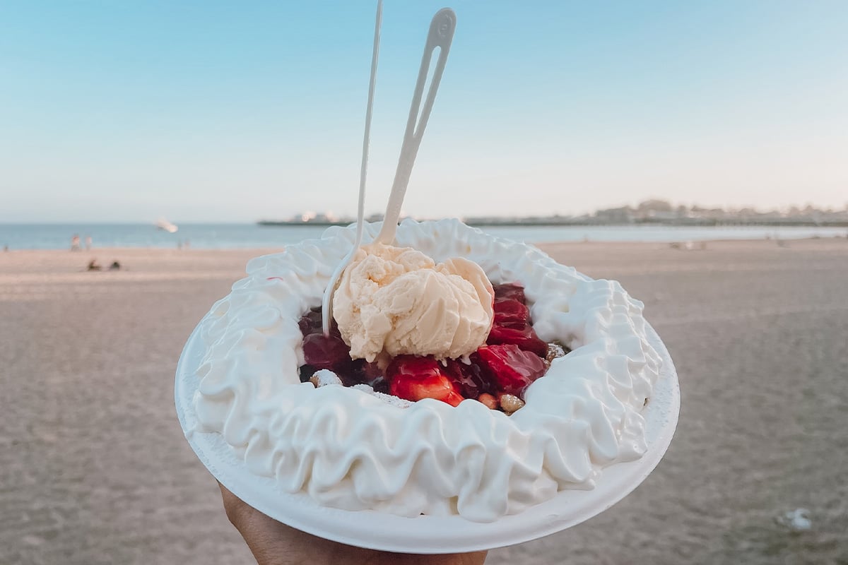 Funnel Cake with the beach in the background. Photographed by Rachel Endsley