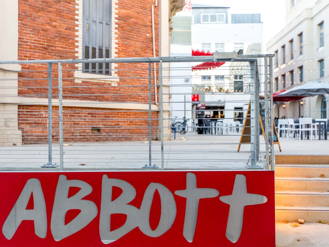 Abbott square wall sign by the steps on Cooper Street.