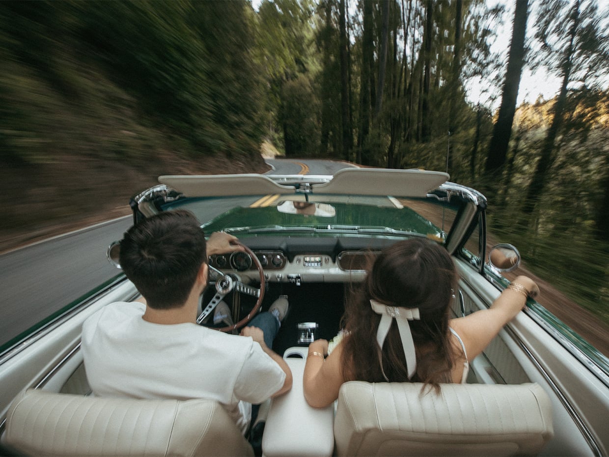 Two people driving in a convertible on Highway 9. Photographed by Ben Ingram
