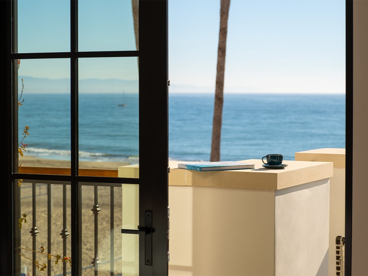 Coffee cup & newspaper placed on the deck of La Bahia Hotel & Spa with an ocean view. Photographed by Daniel Gorosieta