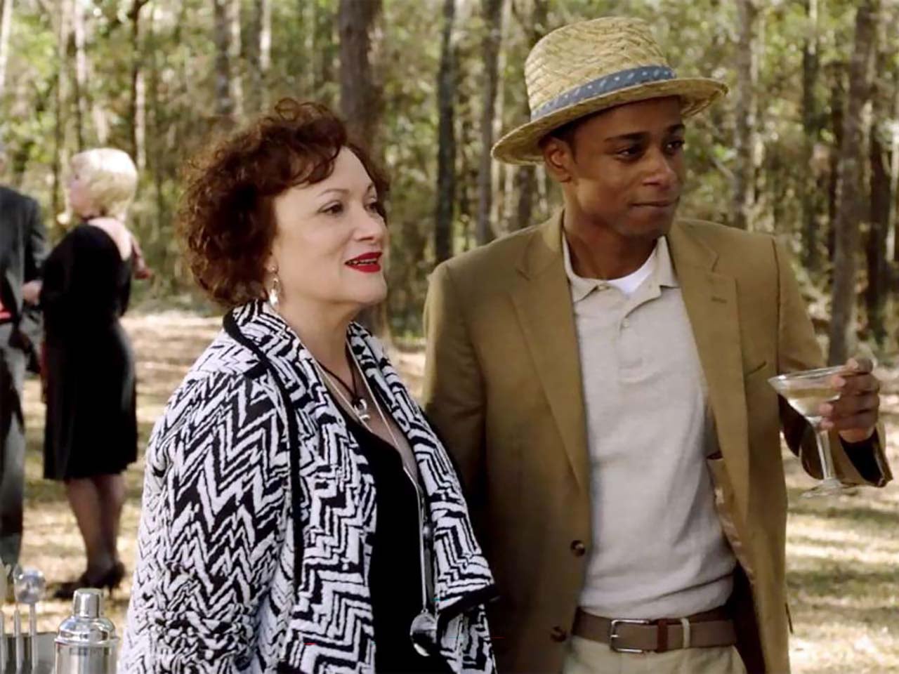 Andre Hayworth character from the movie Get Out holding a cocktail