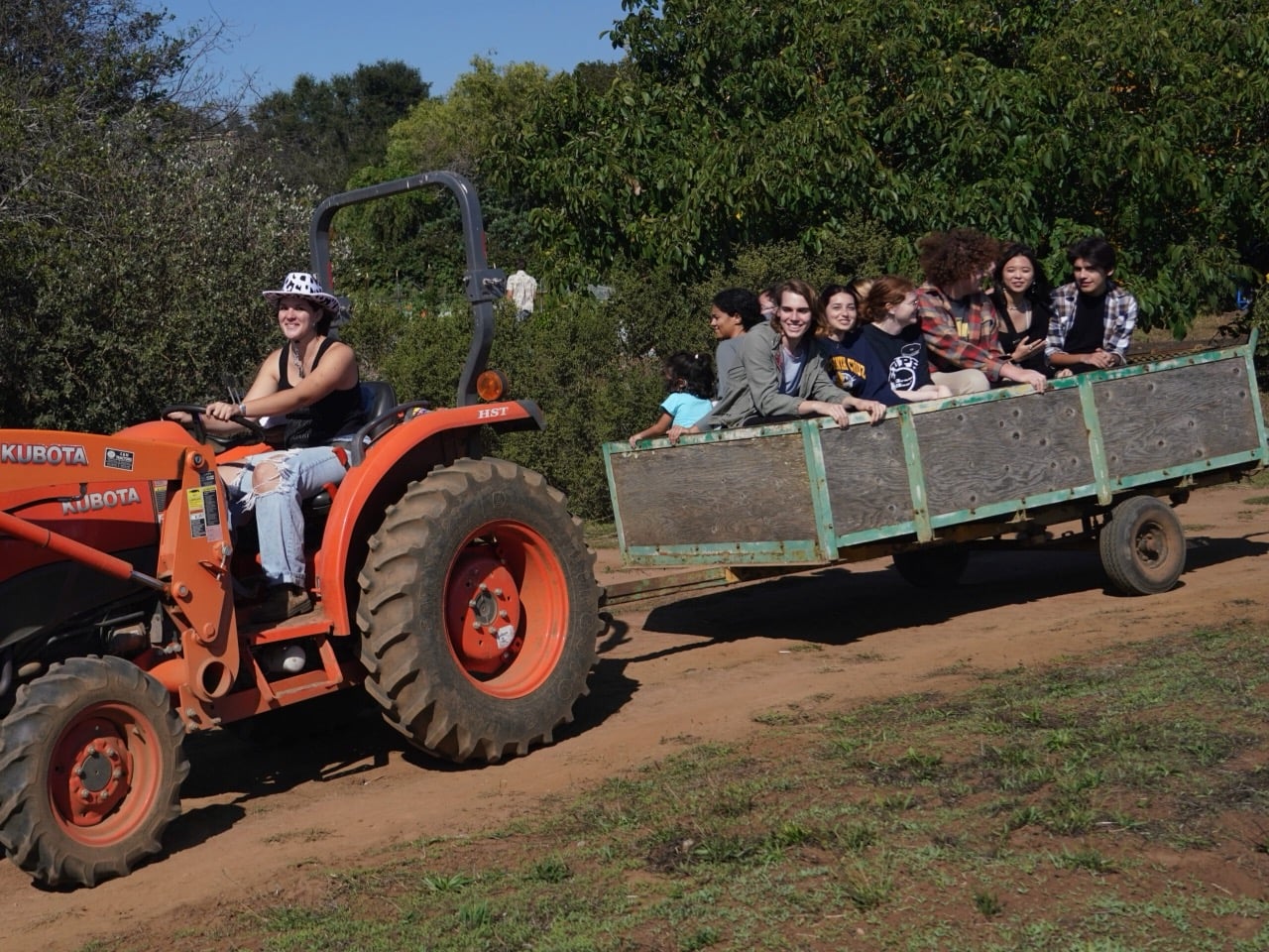 families being pulled in a cart by a tractor